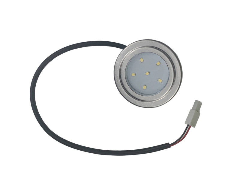 Small circular light fixture with a black cable on a gray background